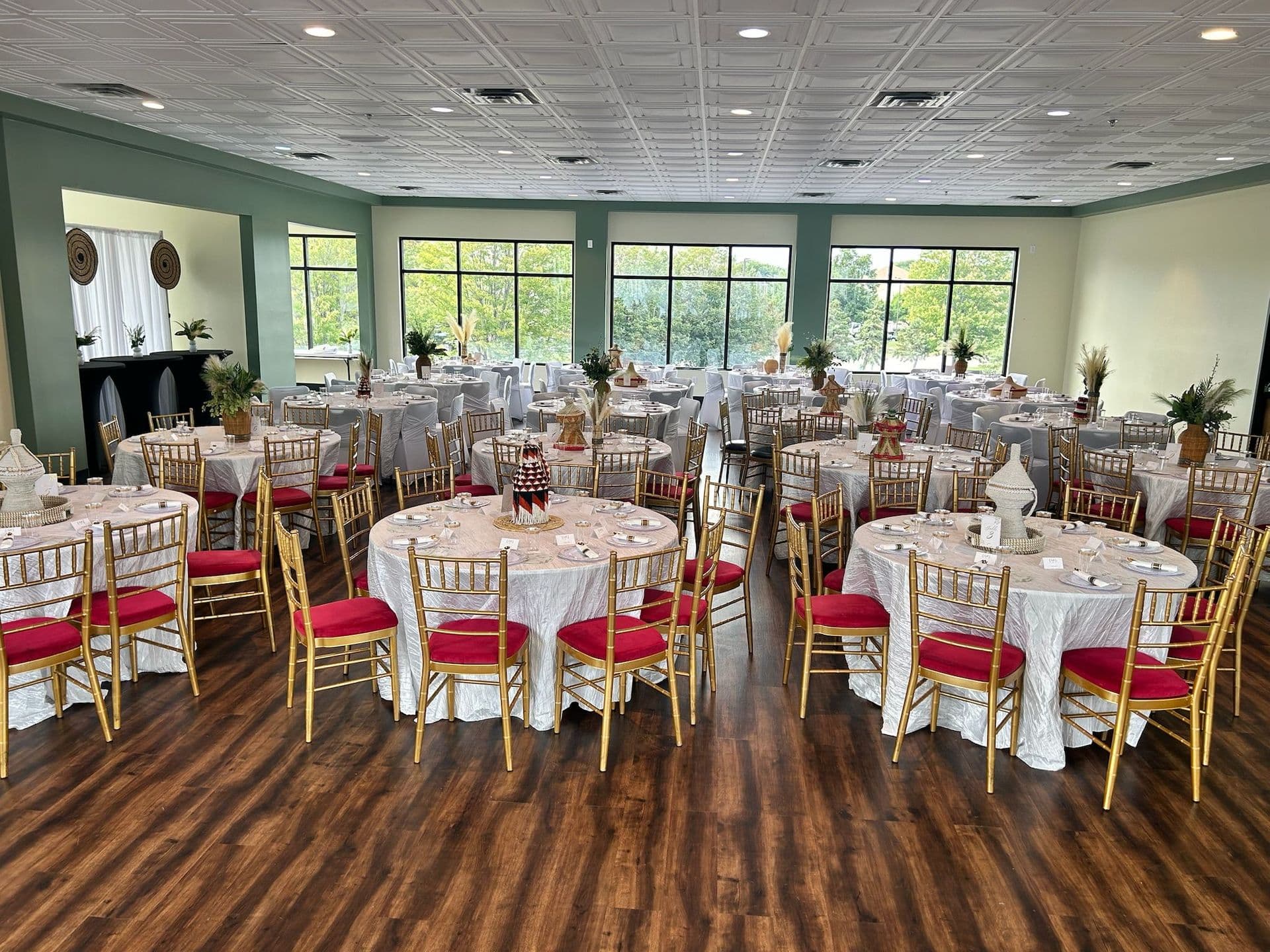 Banquet room with white linens and red-and-gold chiavari chairs near Minneapolis