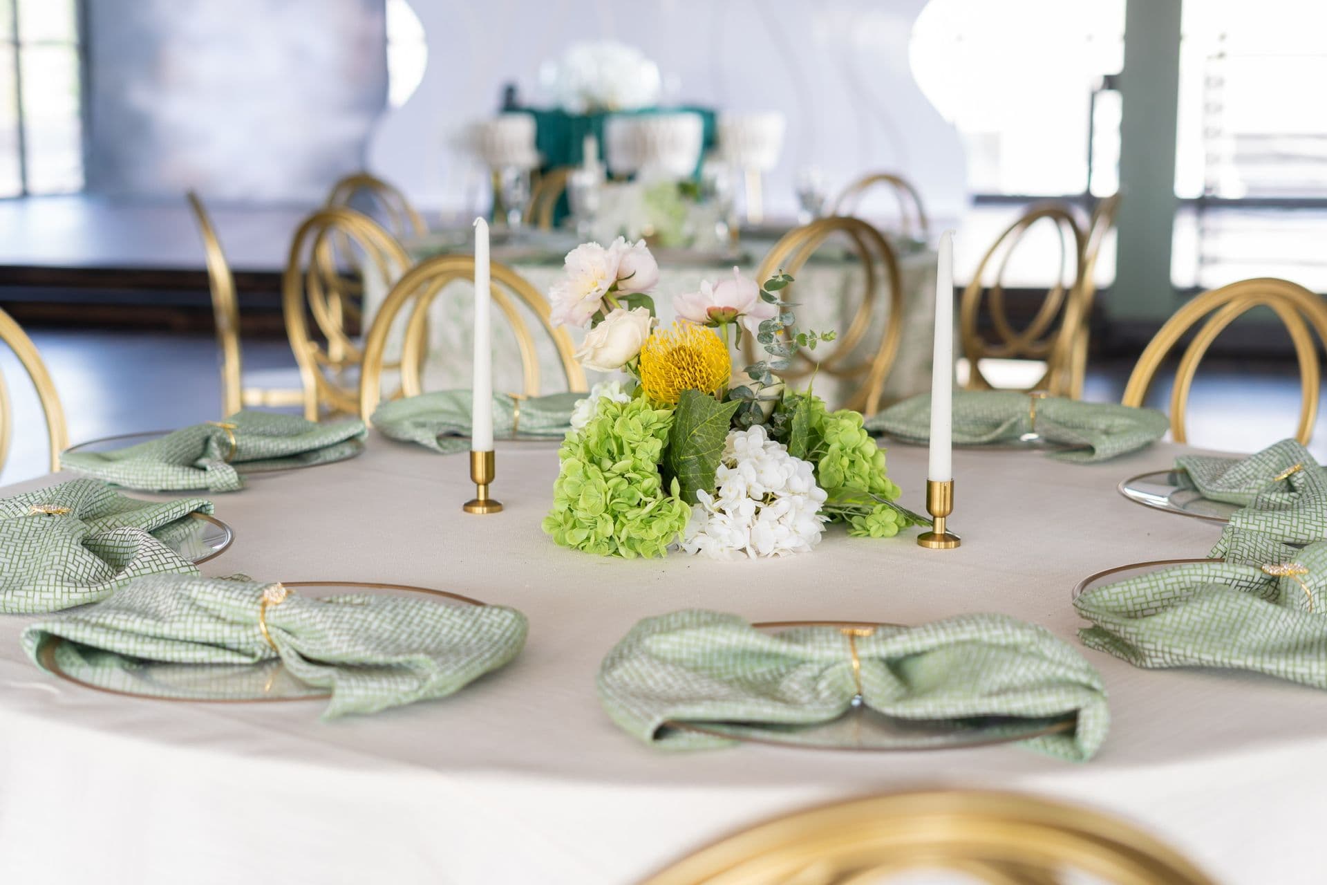 Shower table setting with sage napkins, candles and fresh flowers