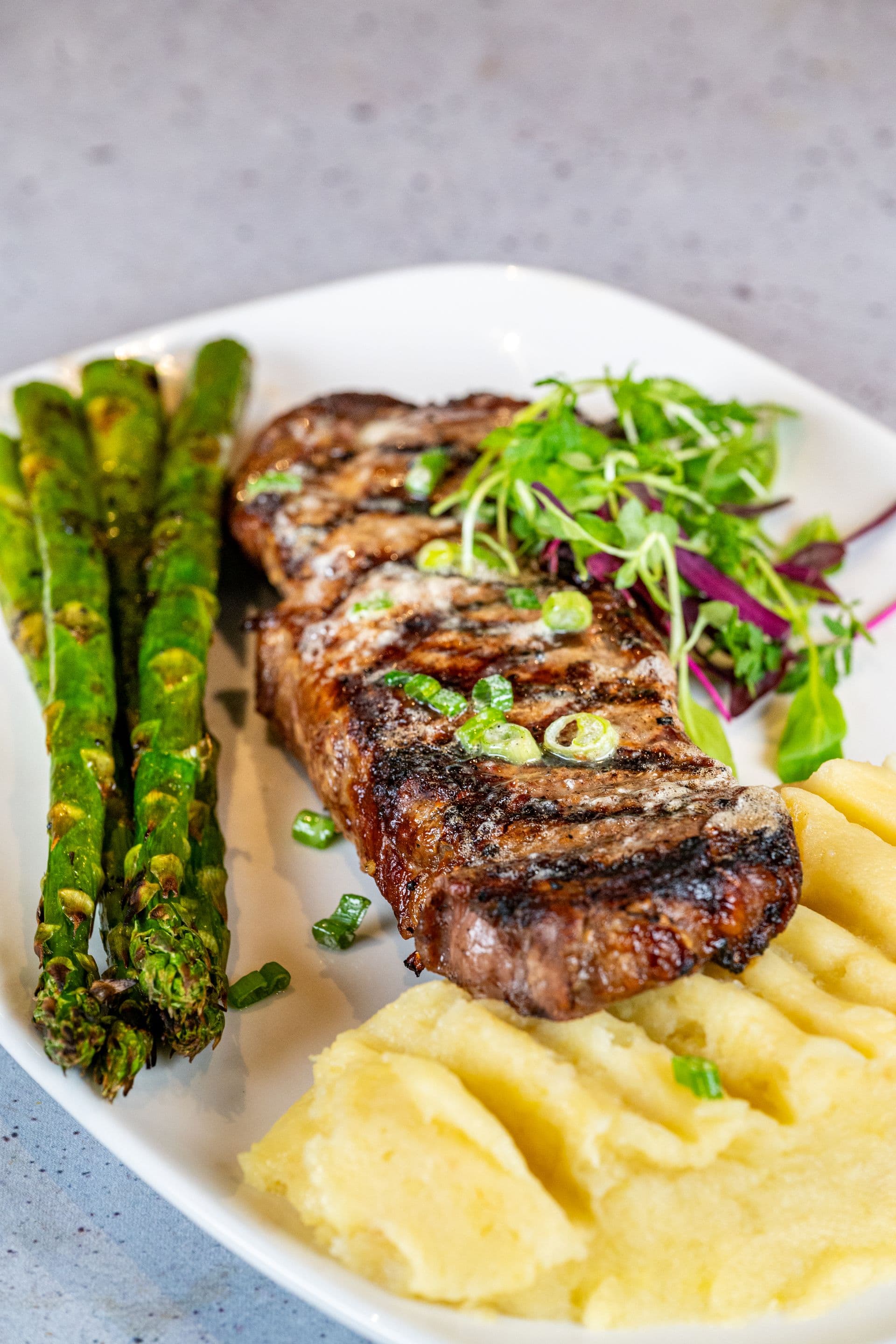 Wood-fired NY strip with asparagus and mashed potatoes